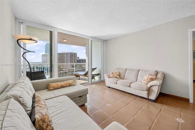 121 Golden Isles Dr Unit 905, Hallandale Beach, FL 33009 - living room featuring a textured ceiling, a city view, tile patterned floors, and expansive windows