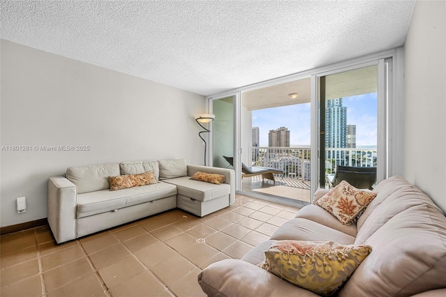 121 Golden Isles Dr Unit 905, Hallandale Beach, FL 33009 - tiled living room with a view of city, expansive windows, and a textured ceiling