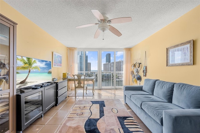121 Golden Isles Dr Unit 905, Hallandale Beach, FL 33009 - living area featuring a textured ceiling, ceiling fan, a wall of windows, and light tile patterned floors