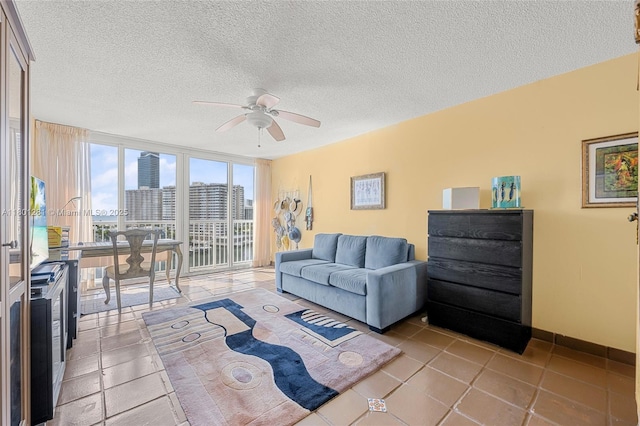 121 Golden Isles Dr Unit 905, Hallandale Beach, FL 33009 - living room with ceiling fan, a textured ceiling, and light tile patterned flooring
