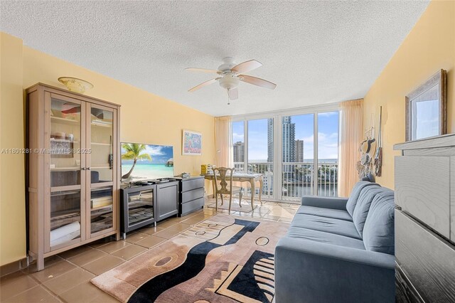 121 Golden Isles Dr Unit 905, Hallandale Beach, FL 33009 - living area with beverage cooler, a textured ceiling, light tile patterned floors, and ceiling fan