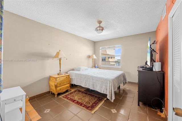 121 Golden Isles Dr Unit 905, Hallandale Beach, FL 33009 - bedroom with a textured ceiling and baseboards