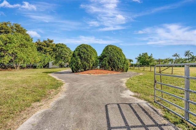 20707 SW 240th St, Homestead, FL 33031 - view of asphalt driveway featuring a gated entry