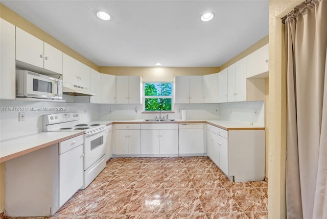 20707 SW 240th St, Homestead, FL 33031 - kitchen featuring white appliances, under cabinet range hood, a sink, light countertops, and recessed lighting