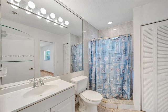 20707 SW 240th St, Homestead, FL 33031 - bathroom with a closet, tiled shower, tile patterned floors, vanity, and a textured ceiling