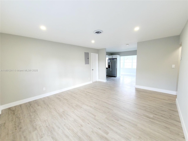 4230 NW 52nd Ave, Lauderdale Lakes, FL 33319 - unfurnished room with baseboards, light wood-style flooring, electric panel, and recessed lighting