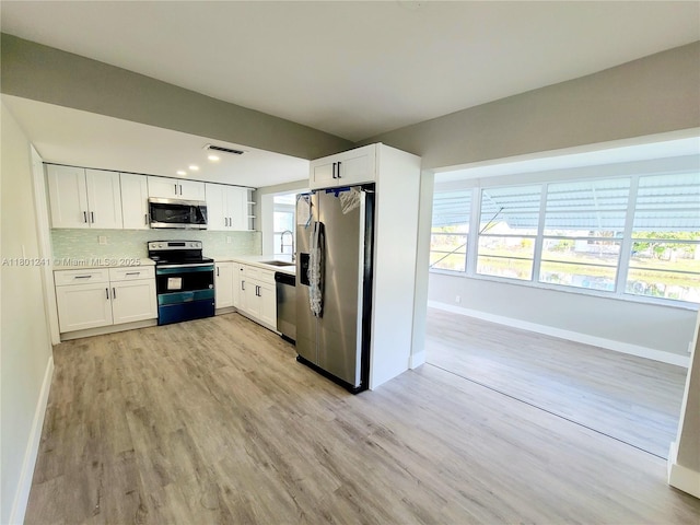 4230 NW 52nd Ave, Lauderdale Lakes, FL 33319 - kitchen featuring appliances with stainless steel finishes, baseboards, backsplash, and recessed lighting