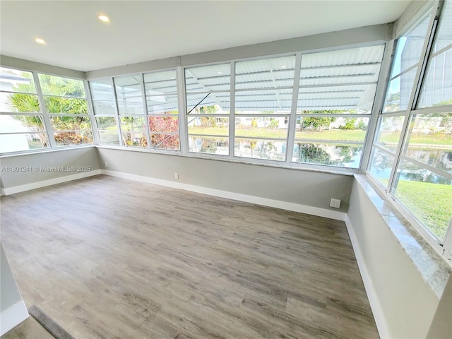 4230 NW 52nd Ave, Lauderdale Lakes, FL 33319 - unfurnished sunroom with healthy amount of natural light, recessed lighting, wood finished floors, and baseboards