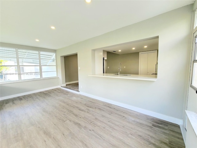 4230 NW 52nd Ave, Lauderdale Lakes, FL 33319 - unfurnished living room with a sink, wood finished floors, recessed lighting, and baseboards