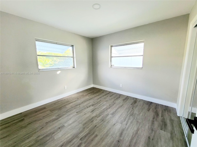 4230 NW 52nd Ave, Lauderdale Lakes, FL 33319 - unfurnished room with healthy amount of natural light, wood finished floors, and baseboards