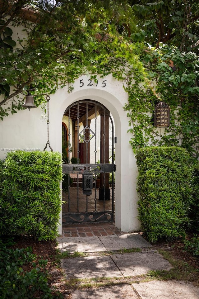 5215 Pine Tree Dr, Miami Beach, FL 33140 - entrance to property with a gate and stucco siding