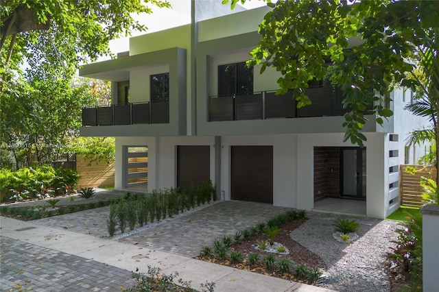 3637 SW 3rd Ave Right, Unit Right, Miami, FL 33145 - modern home with a balcony, stucco siding, driveway, and an attached garage