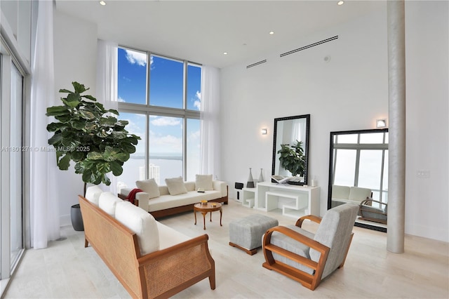 495 Brickell Ave Unit 4102, Miami, FL 33131 - living room with a towering ceiling, light wood-style flooring, and recessed lighting