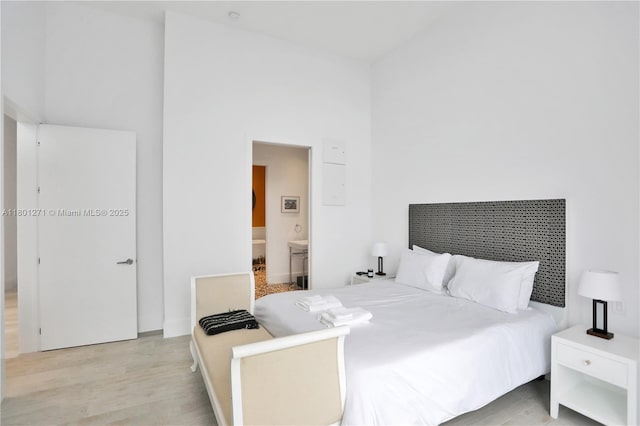 495 Brickell Ave Unit 4102, Miami, FL 33131 - bedroom featuring wood finished floors, ensuite bath, and baseboards