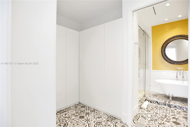495 Brickell Ave Unit 4102, Miami, FL 33131 - bathroom featuring a stall shower, a freestanding bath, recessed lighting, and tile patterned floors