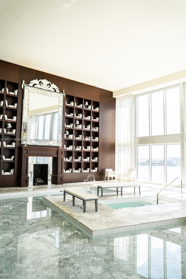 495 Brickell Ave Unit 4102, Miami, FL 33131 - unfurnished living room with marble tiled floors, a fireplace, and a water view