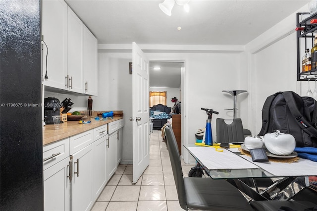 621 E 8th St, Hialeah, FL 33010 - kitchen with light countertops, white cabinets, and light tile patterned floors