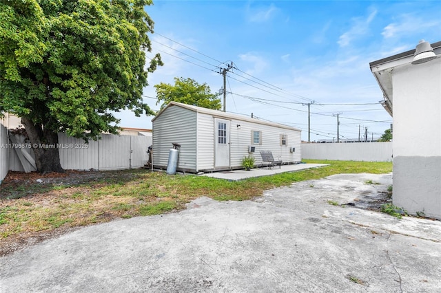 621 E 8th St, Hialeah, FL 33010 - rear view of property with a patio area, a fenced backyard, and an outbuilding