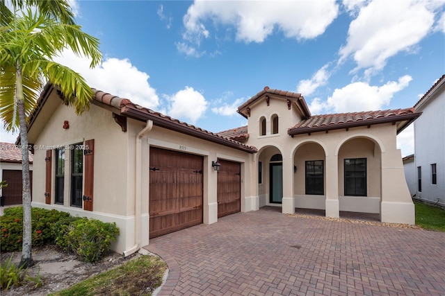 8513 NW 41st St, Cooper City, FL 33024 - mediterranean / spanish home with a garage, stucco siding, decorative driveway, and a tiled roof