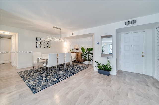 1201 S Ocean Dr Unit 1105N, Hollywood, FL 33019 - dining area with baseboards and a chandelier