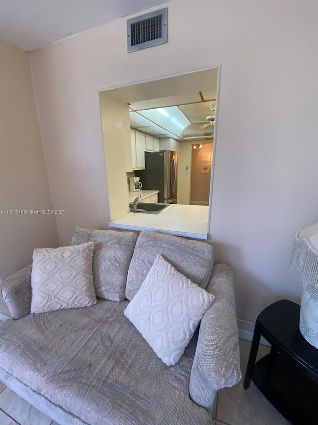 bedroom with freestanding refrigerator and a sink