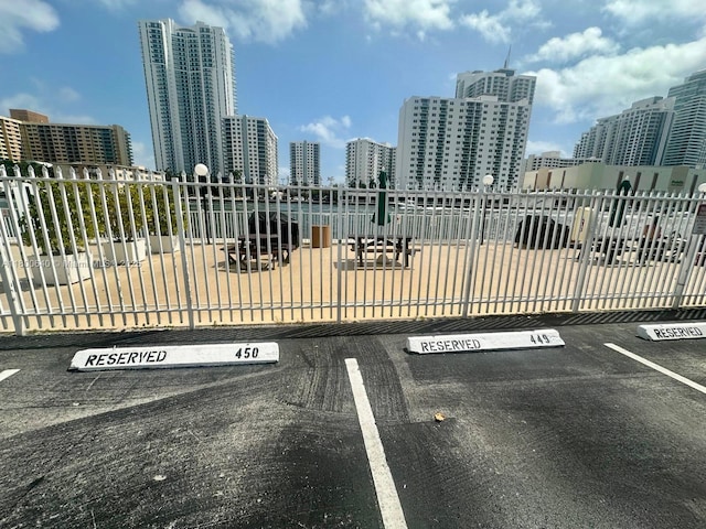 uncovered parking lot featuring a view of skyline
