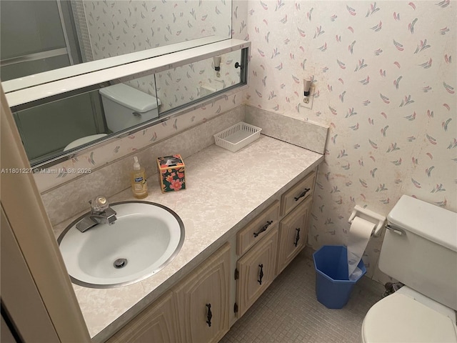 1022 Circle Dr Unit D, Delray Beach, FL 33445 - bathroom with wallpapered walls, toilet, and vanity