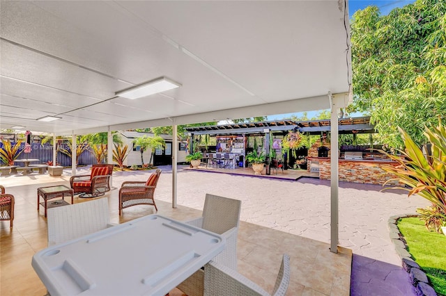 7011 Raleigh St, Hollywood, FL 33024 - view of patio featuring fence, outdoor dining area, a pergola, an outbuilding, and a storage unit