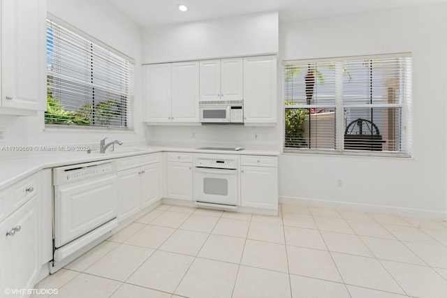 1576 Breakwater Ter, Hollywood, FL 33019 - kitchen with white appliances, light countertops, healthy amount of natural light, and recessed lighting