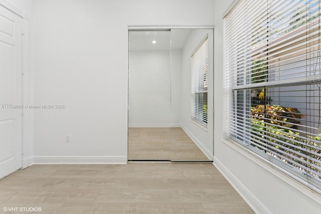1576 Breakwater Ter, Hollywood, FL 33019 - hallway featuring baseboards and light wood-style floors