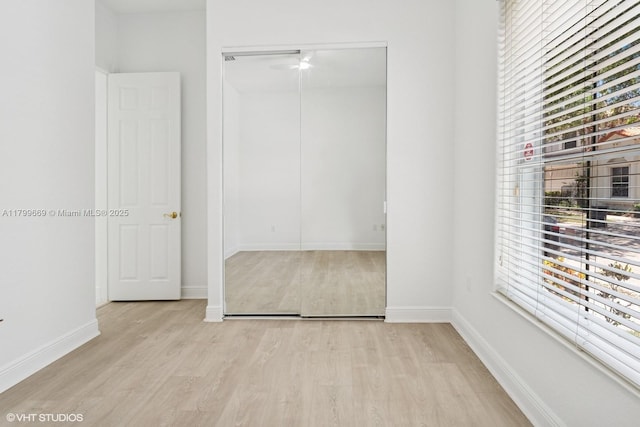 1576 Breakwater Ter, Hollywood, FL 33019 - unfurnished bedroom with light wood finished floors, multiple windows, and a closet