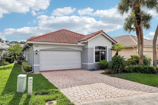 21660 Hammock Point Dr, Boca Raton, FL 33433 - mediterranean / spanish home with decorative driveway, an attached garage, stucco siding, and a front yard
