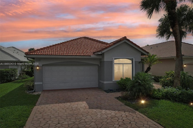 21660 Hammock Point Dr, Boca Raton, FL 33433 - mediterranean / spanish-style home with stucco siding, a garage, a front lawn, and decorative driveway