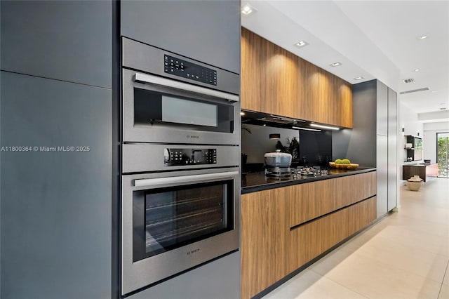 4275 Prairie Ave, Miami Beach, FL 33140 - kitchen featuring dark countertops, stainless steel double oven, modern cabinets, recessed lighting, and gas stovetop
