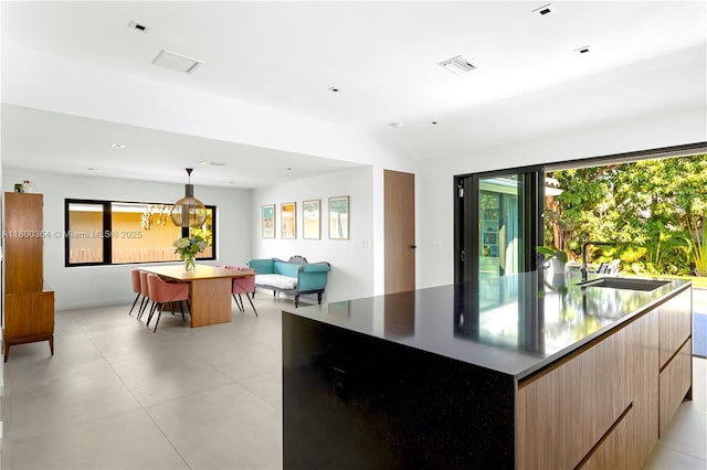 4275 Prairie Ave, Miami Beach, FL 33140 - kitchen featuring modern cabinets, a large island, a sink, light brown cabinetry, and open floor plan