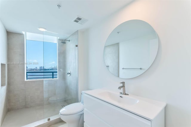 335 S Biscayne Blvd Unit 1012, Miami, FL 33131 - bathroom featuring toilet, a tile shower, and vanity