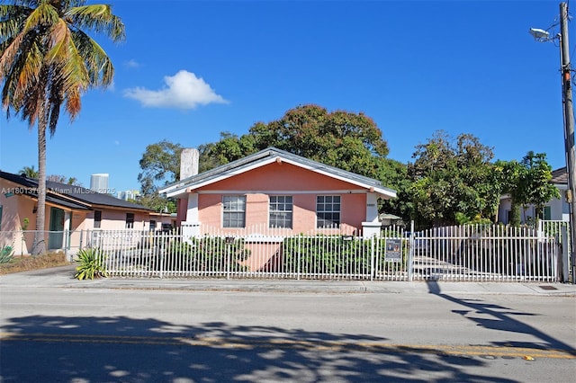 1237 SW 12th Ave, Miami, FL 33129 - view of front facade featuring a fenced front yard, stucco siding, and a chimney
