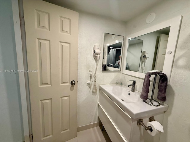 19201 Collins Ave Unit 241, Sunny Isles Beach, FL 33160 - bathroom featuring a textured wall and vanity