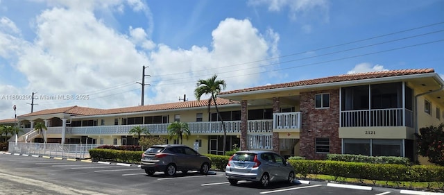 view of building exterior with uncovered parking