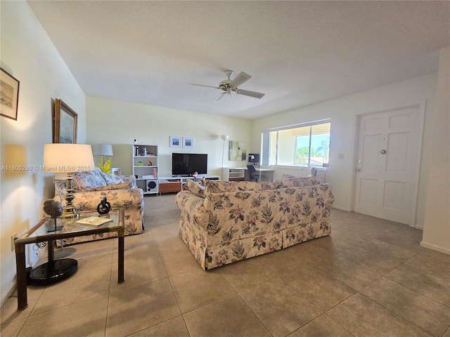 tiled living area featuring ceiling fan and baseboards