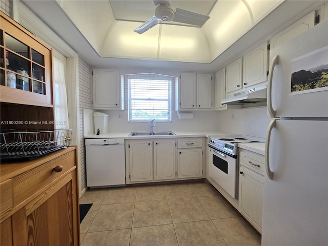 kitchen with white appliances, under cabinet range hood, a sink, ceiling fan, and light countertops