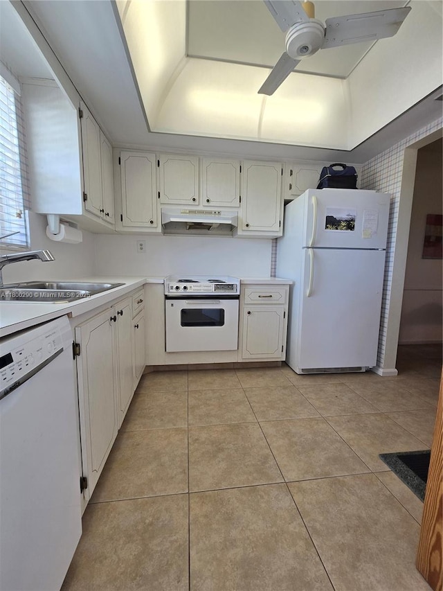 kitchen with white appliances, a sink, under cabinet range hood, a ceiling fan, and light countertops
