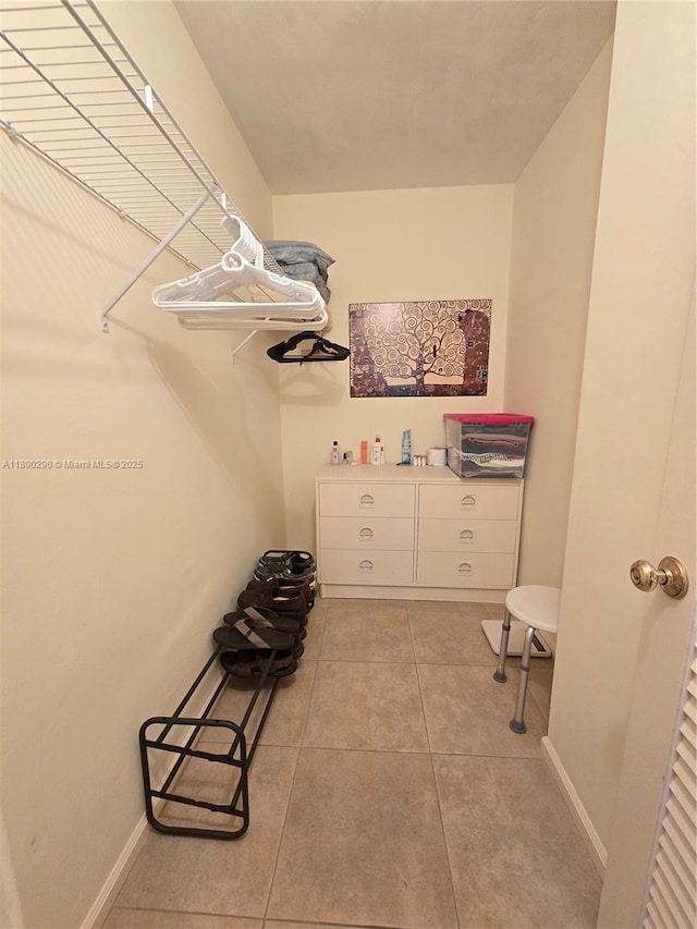 spacious closet with light tile patterned floors