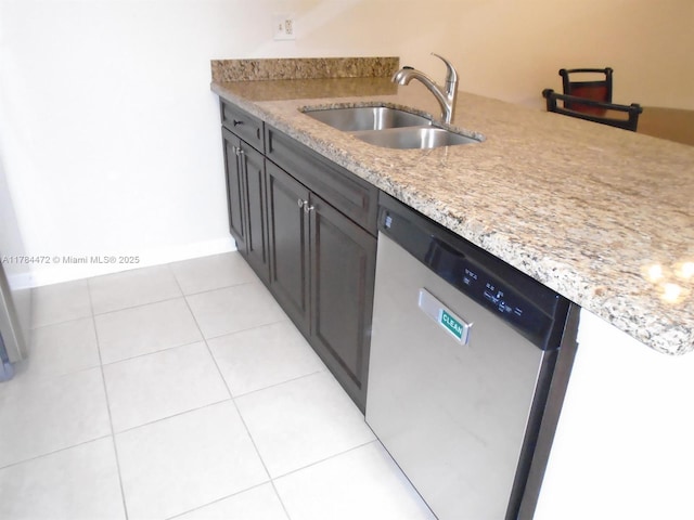 597 Green Springs Pl, West Palm Beach, FL 33409 - kitchen featuring dishwasher, a sink, light tile patterned flooring, and light stone countertops