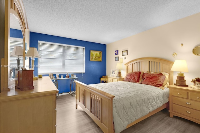 325 NW 72nd Ave Unit 308, Miami, FL 33126 - bedroom with wood finished floors and a textured ceiling