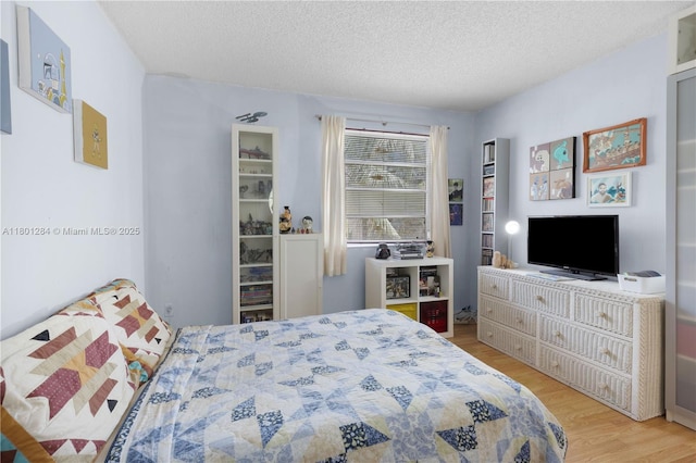 325 NW 72nd Ave Unit 308, Miami, FL 33126 - bedroom with wood finished floors and a textured ceiling