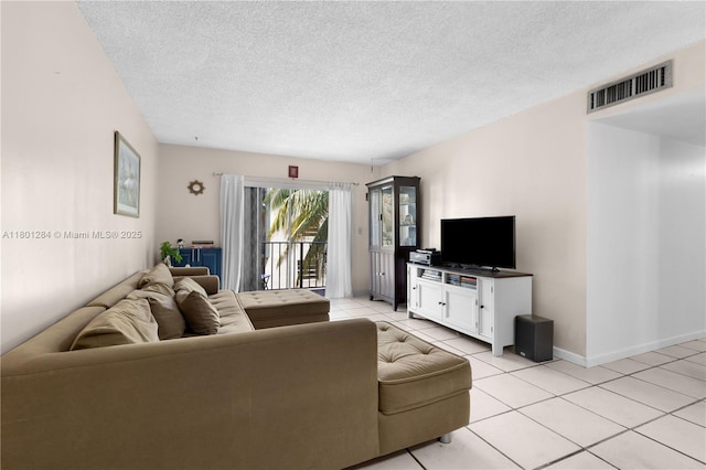 325 NW 72nd Ave Unit 308, Miami, FL 33126 - living area featuring light tile patterned floors, a textured ceiling, and baseboards