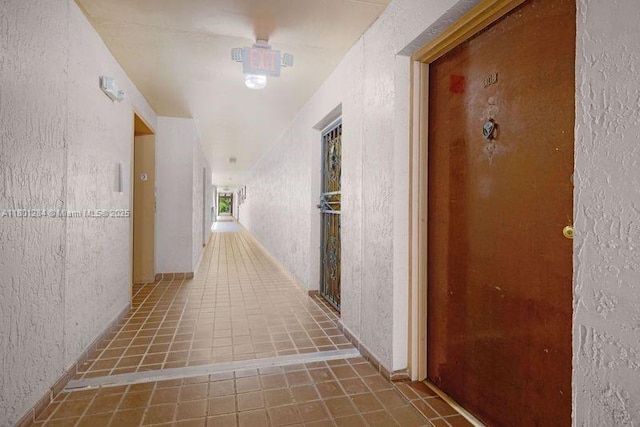 325 NW 72nd Ave Unit 308, Miami, FL 33126 - hall featuring tile patterned floors and a textured wall