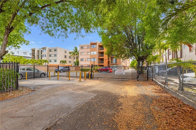 325 NW 72nd Ave Unit 308, Miami, FL 33126 - view of home's community featuring uncovered parking, fence, and a gate