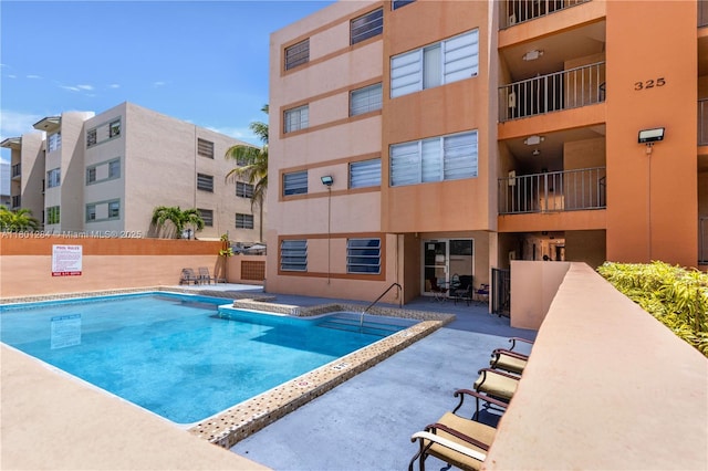 325 NW 72nd Ave Unit 308, Miami, FL 33126 - community pool featuring a patio and fence